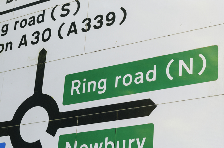 Road sign showing directions to Ring Road from a roundabout