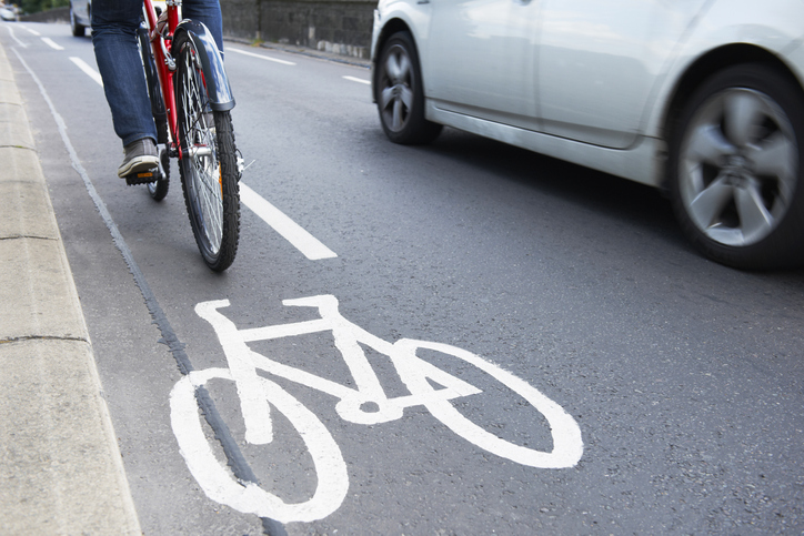 Man riding bicycle in cycle lane