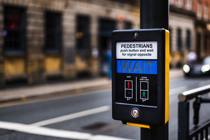 Yellow and black pedestrian crossing button