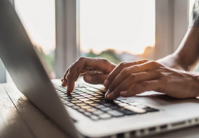 person typing on a laptop